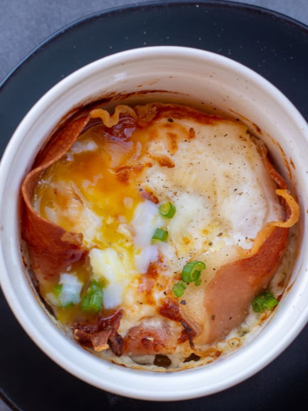 Learn how to make Eggs in the Air Fryer for the ultimate quick and easy breakfast! These easy air fryer eggs feature prosciutto and parmesan and are ready in 10 minutes or less!