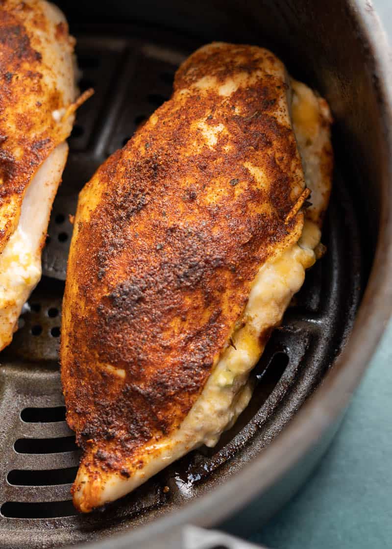 This easy Air Fryer Stuffed Chicken Breast recipe is perfect for a busy weeknight! Naturally gluten free, low carb, and bursting with cheesy, spicy flavor!