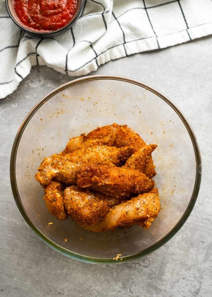 seasoned chicken tenderloins in a bowl